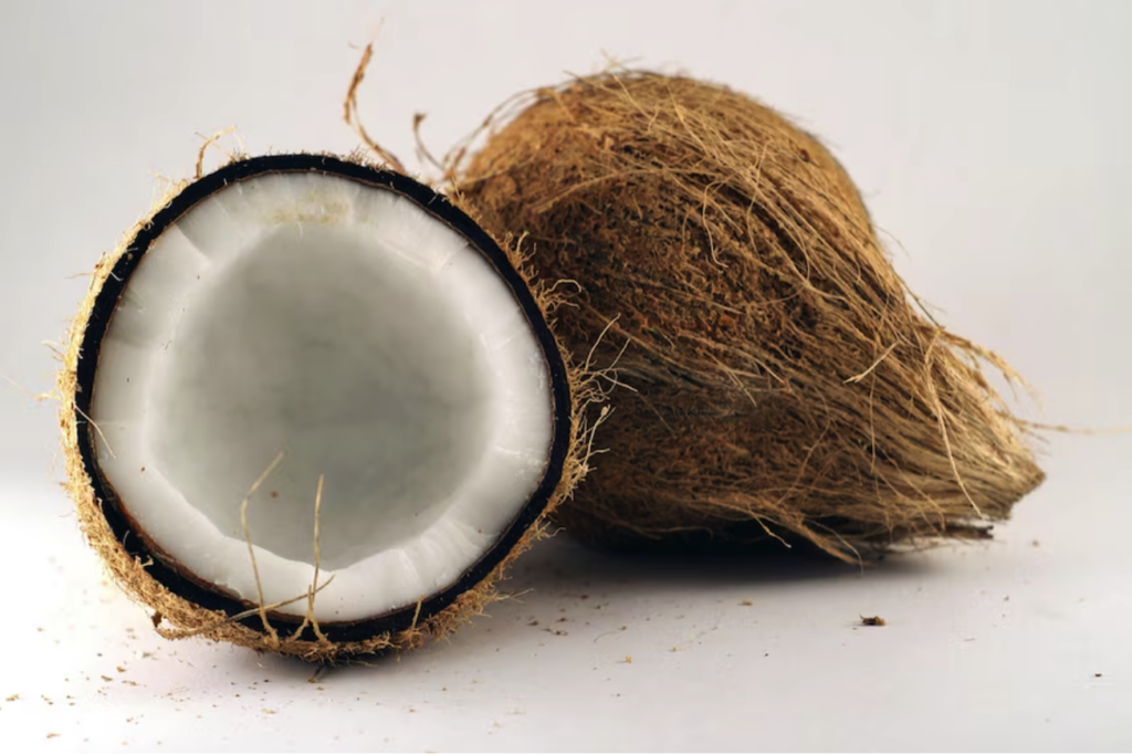 brown ripe coconut with inside view of white coconut meat